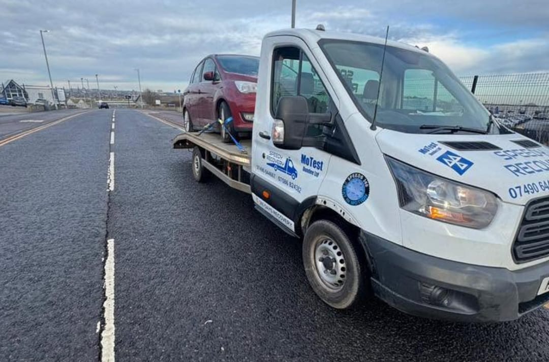 A red Ford C-Max loaded on our flatbed by the Dundee waterfront