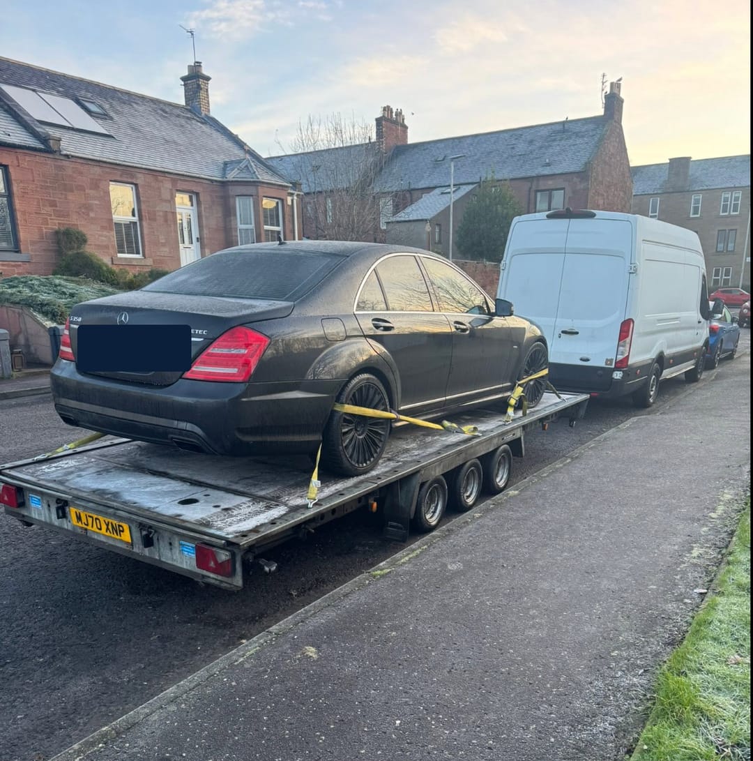 A Mercedes S-Class strapped to our flatbed on a frosty street